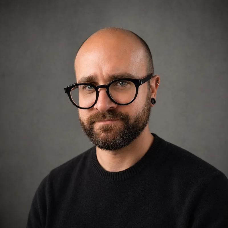 Gabriel Loewen wearing round black glasses and a black sweater